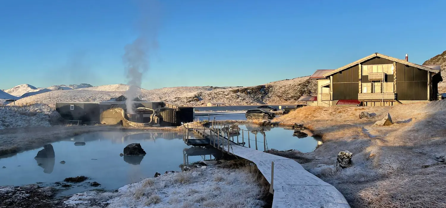 Geothermal pools and elevated walkways beside the Hveradalir lodge